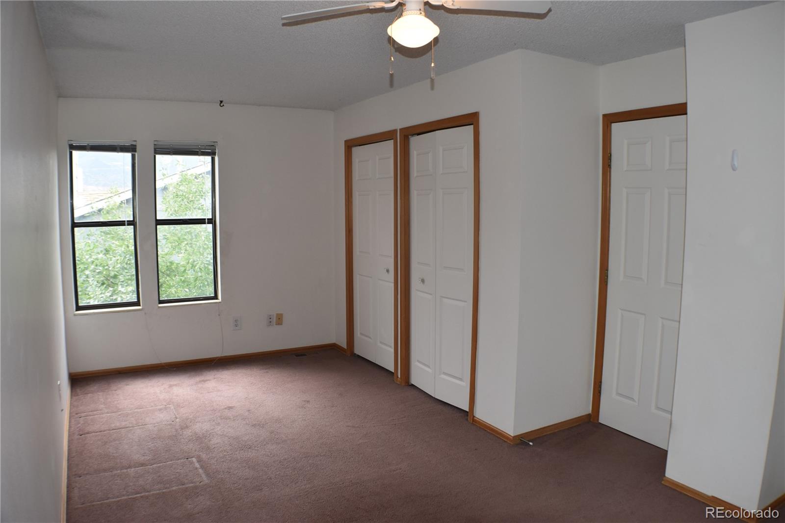 1322 Talley Circle Colorado Springs, CO 80904 - Photo 21 of 32 an empty room with windows and closet