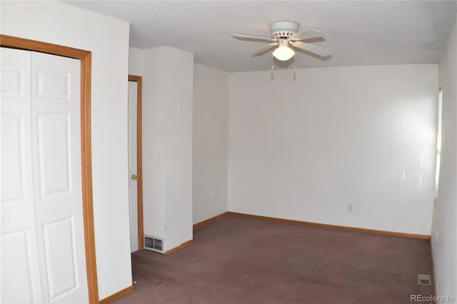 a view of a room with a fan and a fan