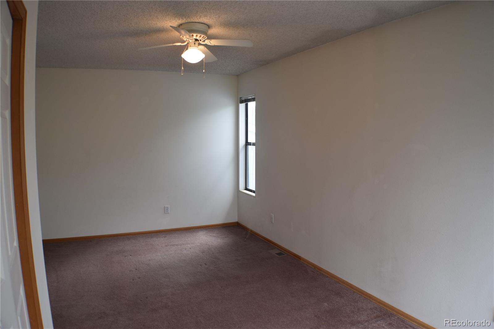 1322 Talley Circle Colorado Springs, CO 80904 - Photo 24 of 32 an empty room with windows and fan