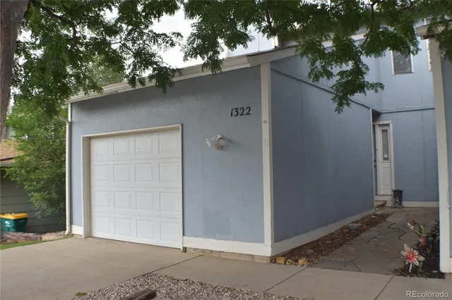 a front view of a house with a tree
