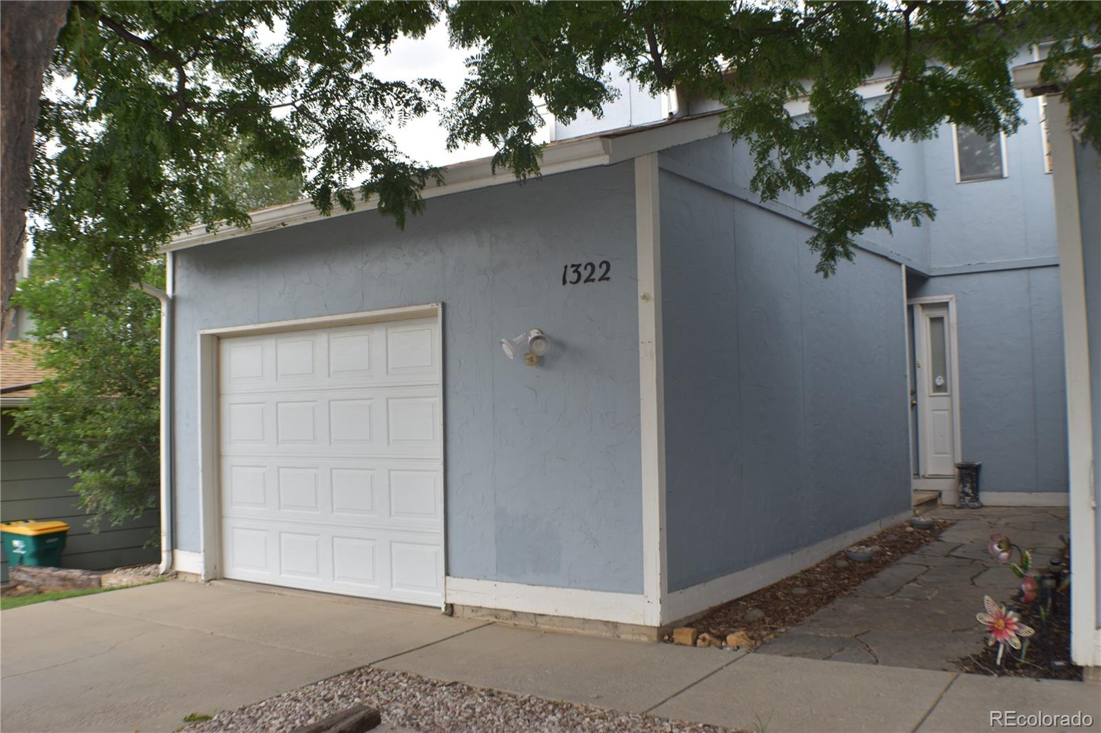 1322 Talley Circle Colorado Springs, CO 80904 - Photo 3 of 32 a front view of a house with a tree
