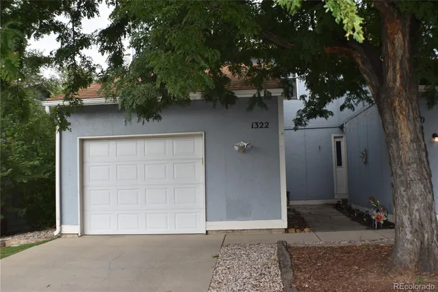 front view of a house with a tree
