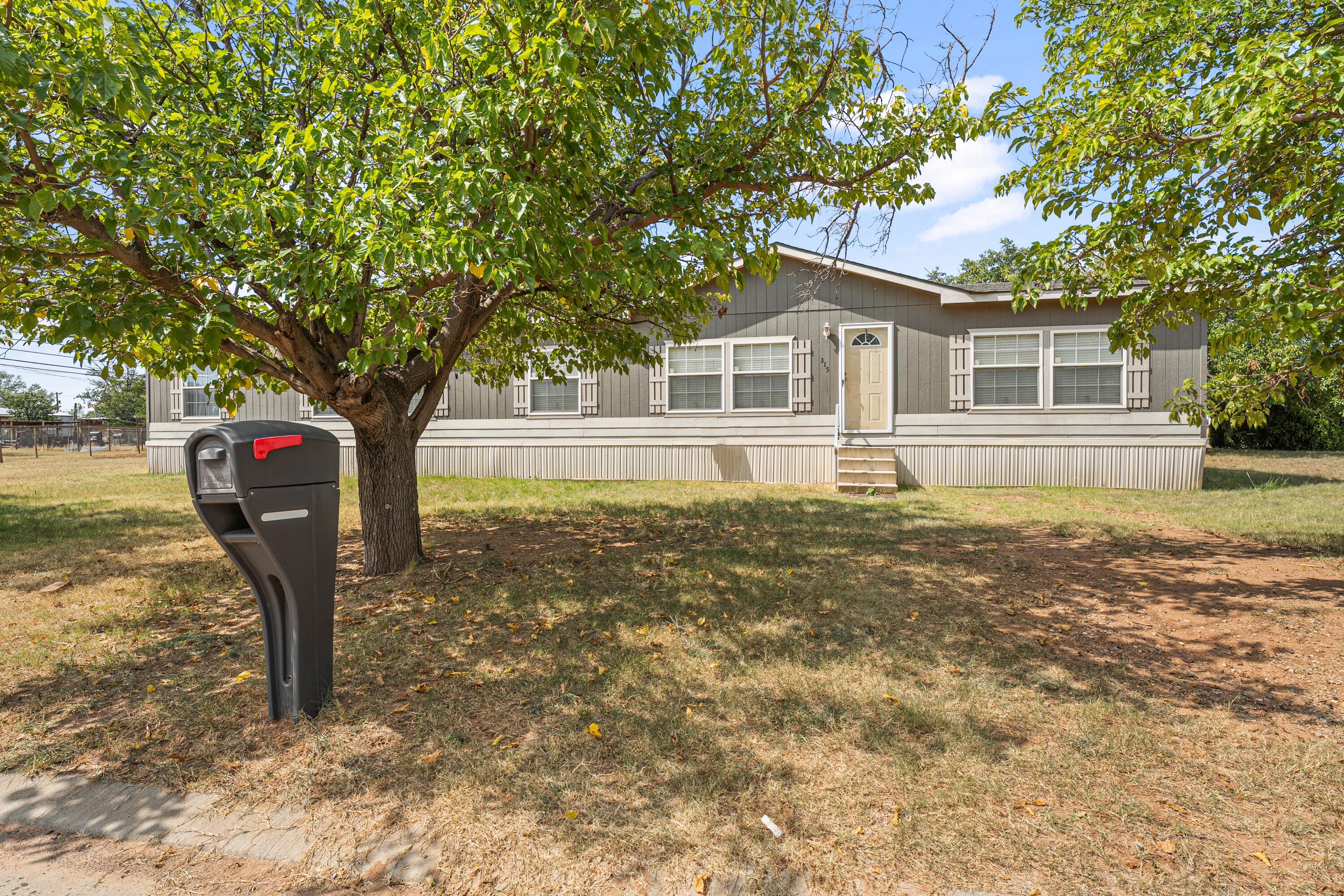 315 N Avenue North Post, TX 79356 - Photo 1 of 23 a front view of a house with a yard