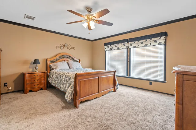 a bedroom with a large bed and a large window