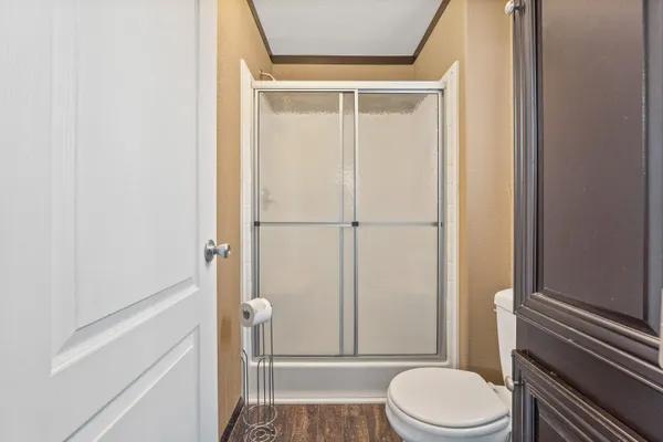 a bathroom with a toilet and a shower