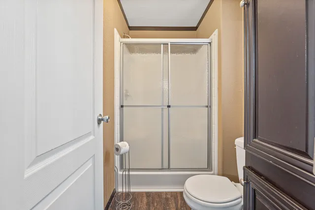 a bathroom with a toilet and a shower