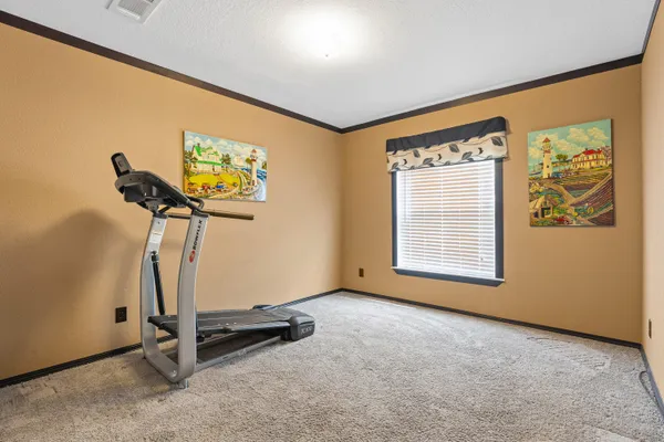 a room with gym equipment and windows