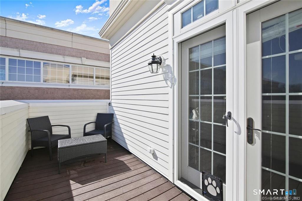 1241 Post Road Fairfield, CT 06824 - Photo 11 of 13 a view of a balcony with chair and table