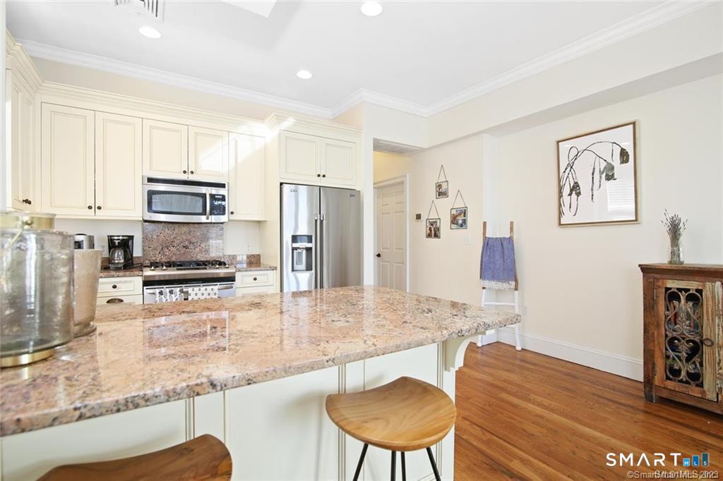 1241 Post Road Fairfield, CT 06824 - Photo 5 of 13 a kitchen with stainless steel appliances granite countertop a refrigerator and a stove top oven