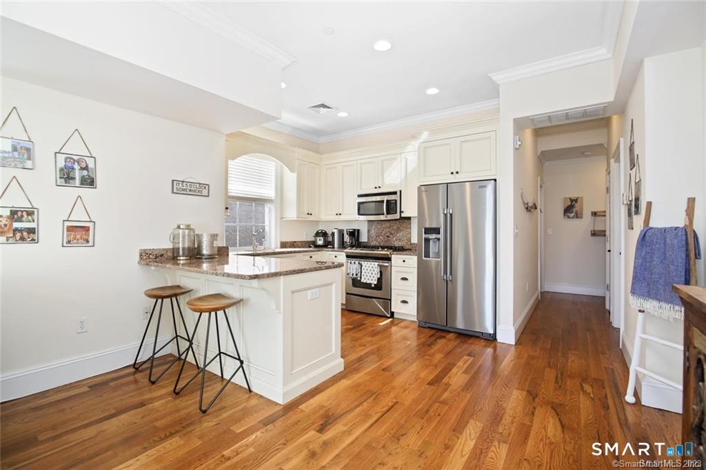 1241 Post Road Fairfield, CT 06824 - Photo 6 of 13 a kitchen with stainless steel appliances granite countertop a refrigerator and a stove top oven