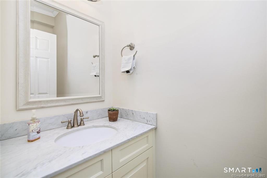 1241 Post Road Fairfield, CT 06824 - Photo 7 of 13 a bathroom with a granite countertop sink and a mirror