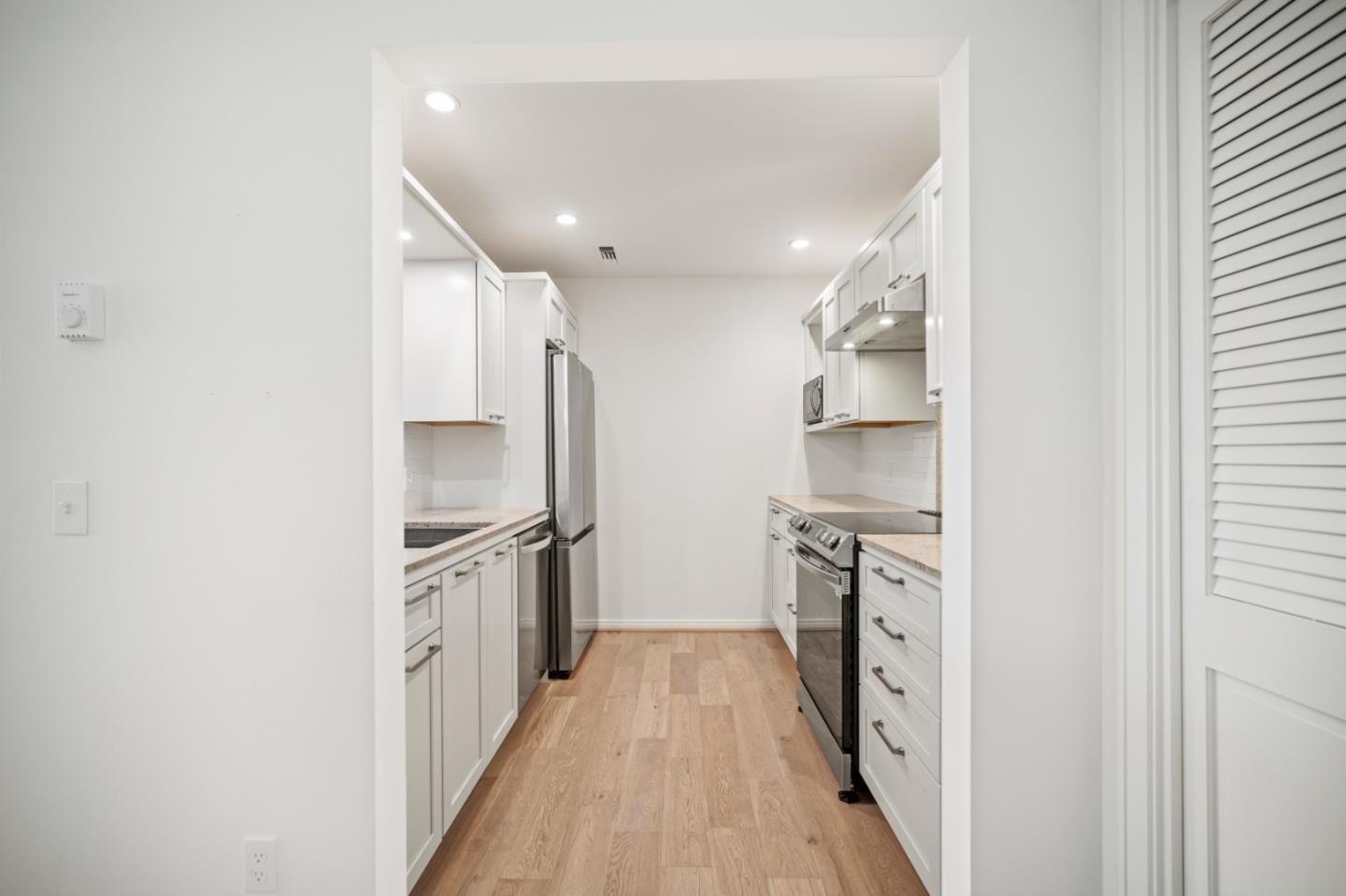 0 Northeast Ne Corner, Unit 1 Carmel, CA 93923 - Photo 12 of 33 a kitchen with stainless steel appliances granite countertop a refrigerator and a stove top oven