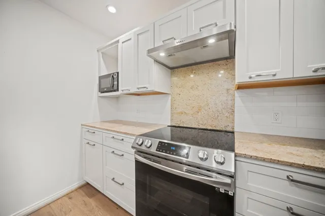 a kitchen with a stove and a microwave