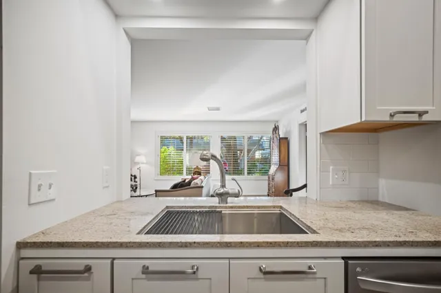 a kitchen with a sink and a large window