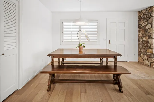 a view of a room with a table and windows