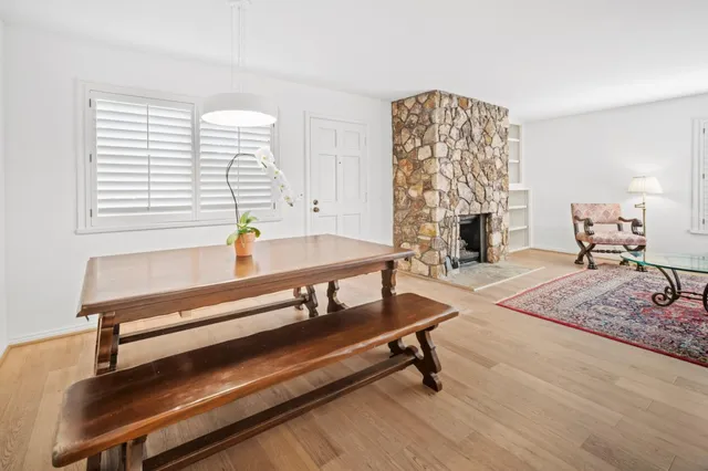 a living room with furniture a fireplace and next to a window