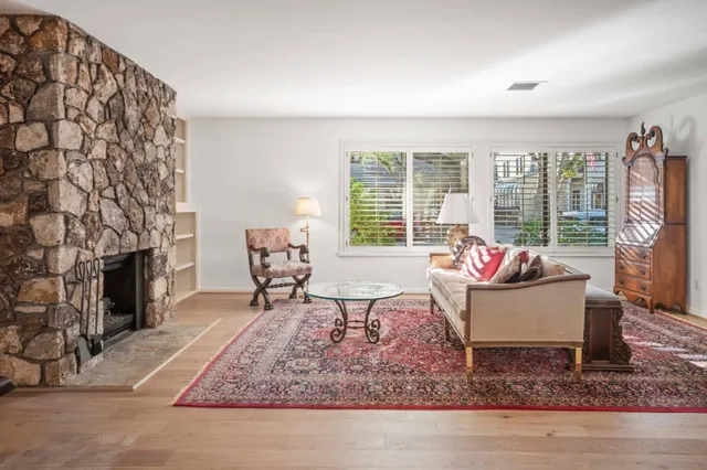 a living room with furniture and a fireplace