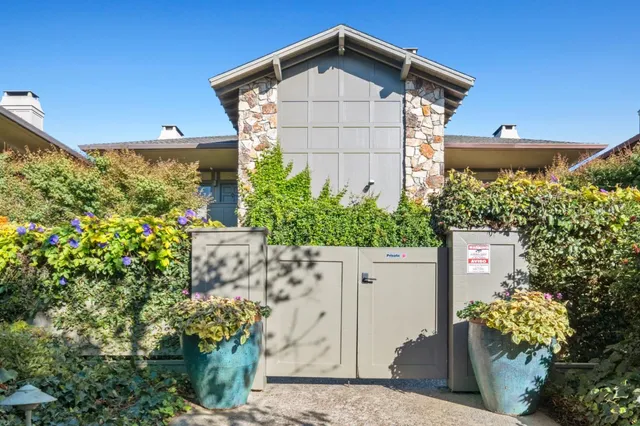 a front view of a house with plants