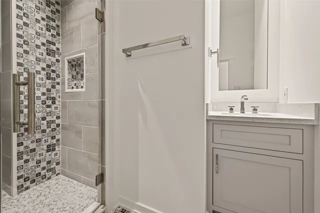 a bathroom with a shower and a sink