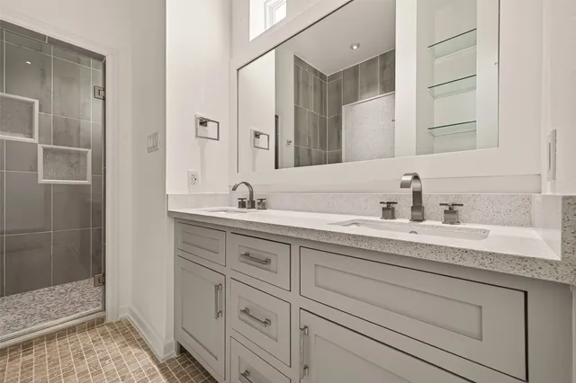 a bathroom with double sink and a mirror