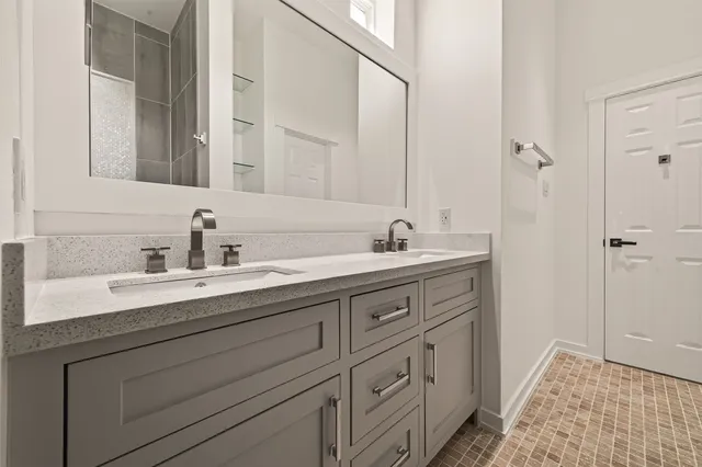 a bathroom with a double vanity sink mirror and