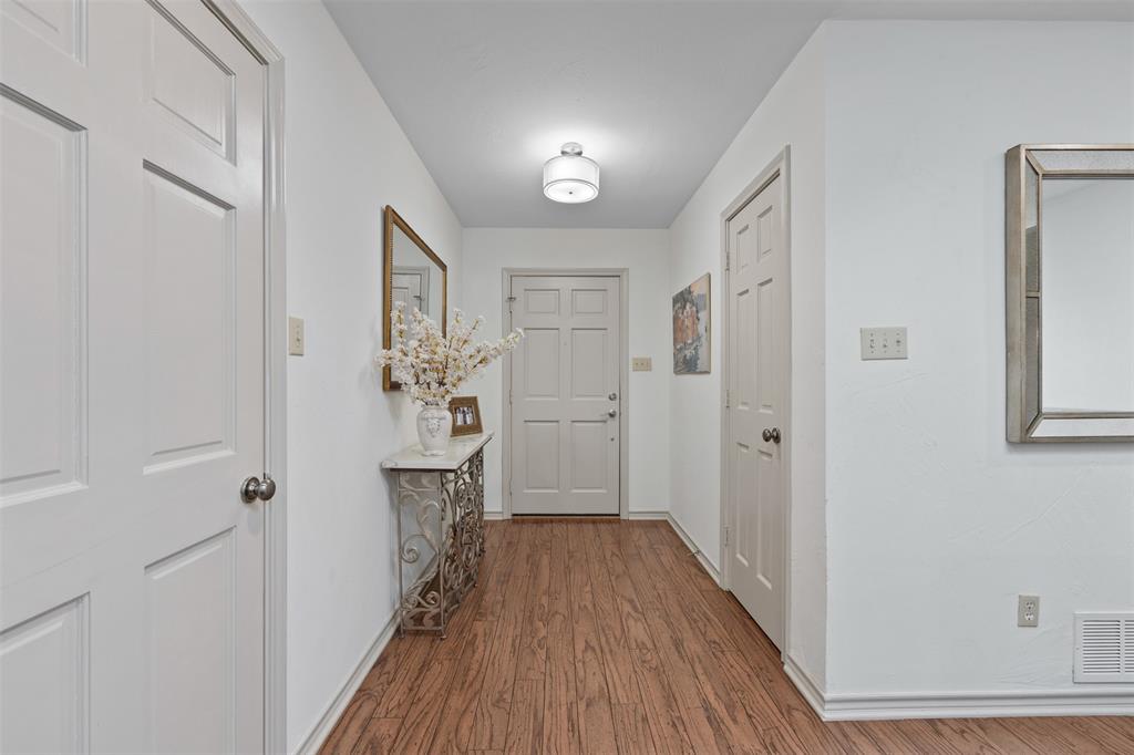 318 Ridge Creek Road Waxahachie, TX 75167 - Photo 6 of 40 Wood-finish flooring throughout, white paneled doors, and a flush-mount ceiling light fixture