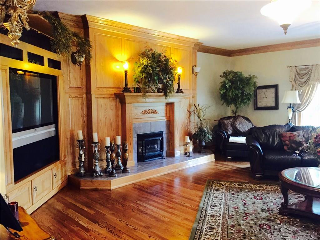 3217 Ellwood Road New Castle, PA 16101 - Photo 6 of 23 GOOD VIEW OF GREAT ROOM BEAUTIFUL HARDWOOD FLOORING AND GAS INSERT IN FIREPLACE FOR THE NOT SO DIRTY FIRE.