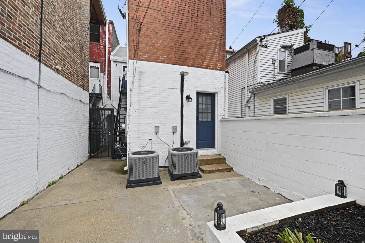 1709 Bank Street Baltimore, MD 21231 - Photo 20 of 49 a view of a patio with a table and chairs and iron fence