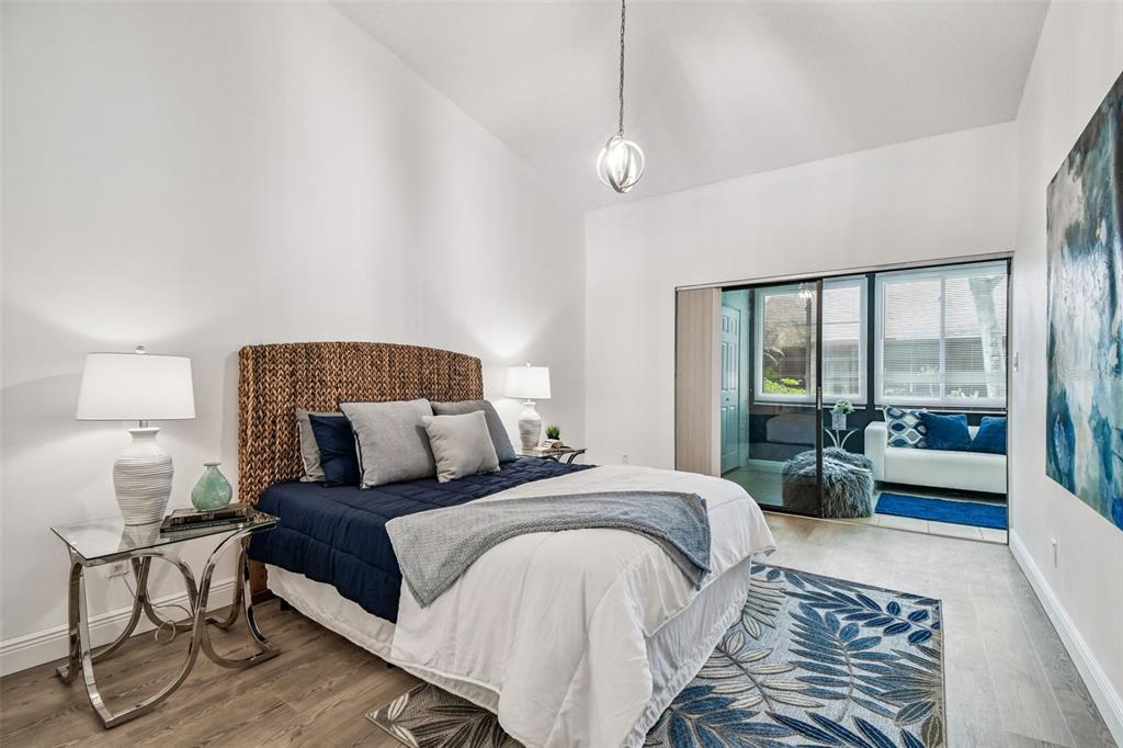 14773 Feather Cove Road Clearwater, FL 33762 - Photo 13 of 25 a bedroom with a large bed and a lamp on table