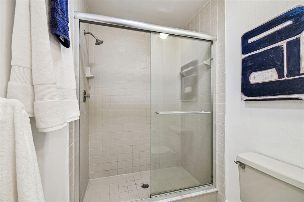 14773 Feather Cove Road Clearwater, FL 33762 - Photo 17 of 25 a bathroom with a shower and toilet