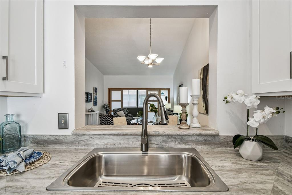 14773 Feather Cove Road Clearwater, FL 33762 - Photo 19 of 25 a kitchen with a sink and a granite counter top