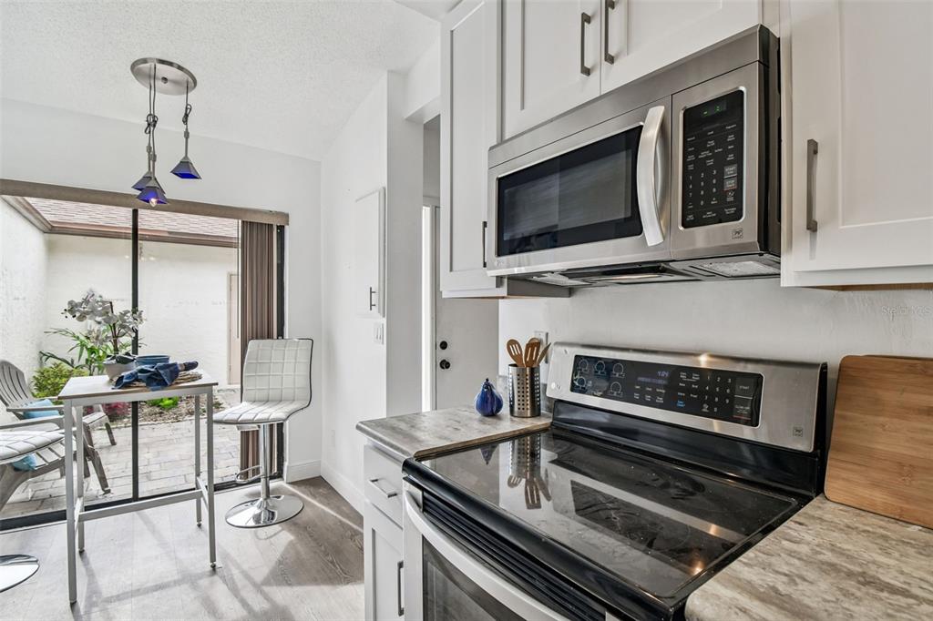 14773 Feather Cove Road Clearwater, FL 33762 - Photo 20 of 25 a kitchen with a stove and a microwave