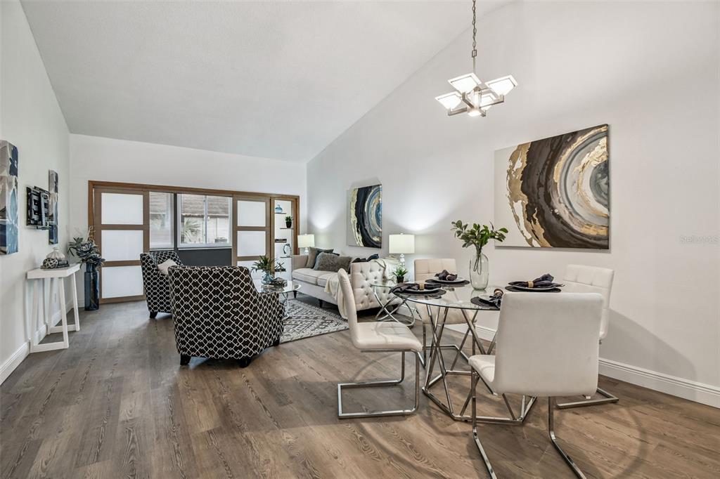 14773 Feather Cove Road Clearwater, FL 33762 - Photo 2 of 25 a living room with furniture a chandelier and wooden floor