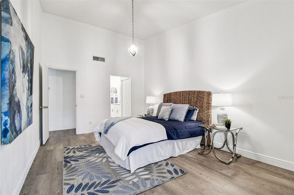 14773 Feather Cove Road Clearwater, FL 33762 - Photo 22 of 25 a bedroom with a bed and a mirror