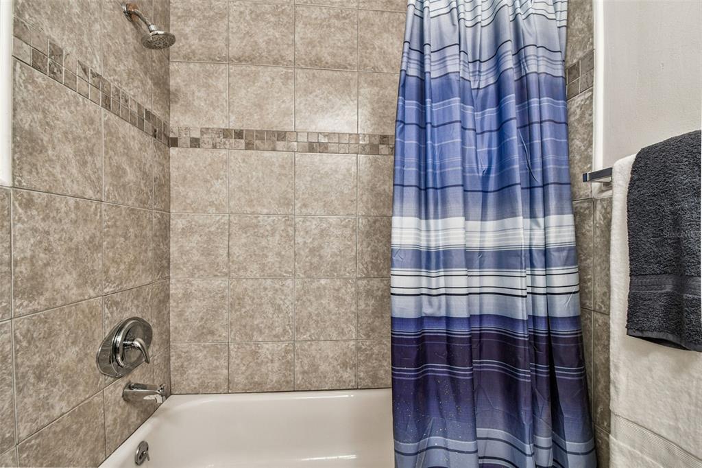 14773 Feather Cove Road Clearwater, FL 33762 - Photo 23 of 25 a bathroom with a bathtub and shower