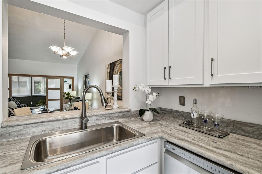 14773 Feather Cove Road Clearwater, FL 33762 - Photo 7 of 25 a kitchen with sink and cabinets