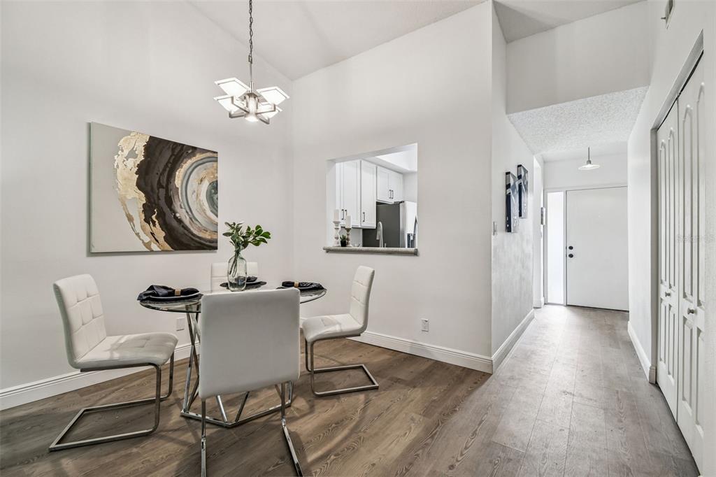 14773 Feather Cove Road Clearwater, FL 33762 - Photo 8 of 25 a view of a dining room with furniture and chandelier