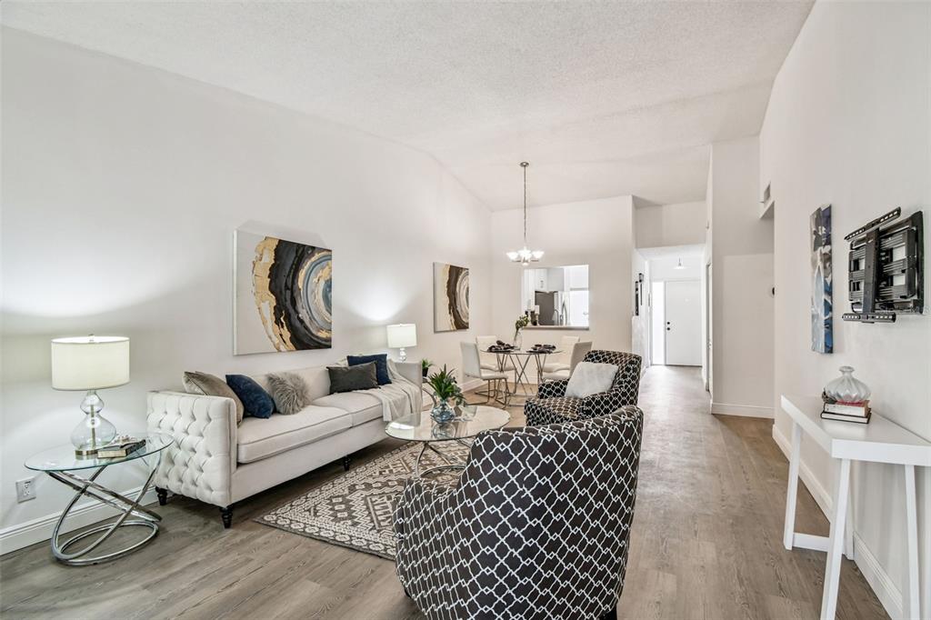 14773 Feather Cove Road Clearwater, FL 33762 - Photo 9 of 25 a living room with furniture and a lamp
