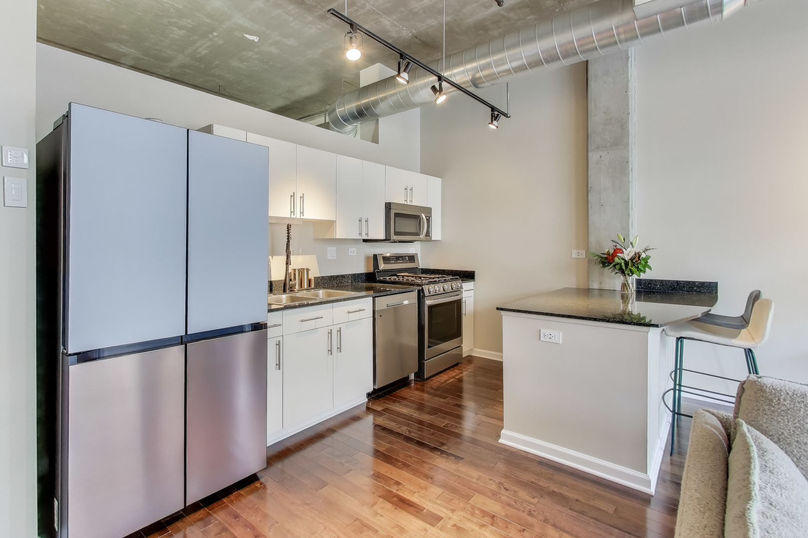 900 North Kingsbury Street, Unit 1019 Chicago, IL 60610 - Photo 11 of 37 a kitchen with a refrigerator cabinets and wooden floor