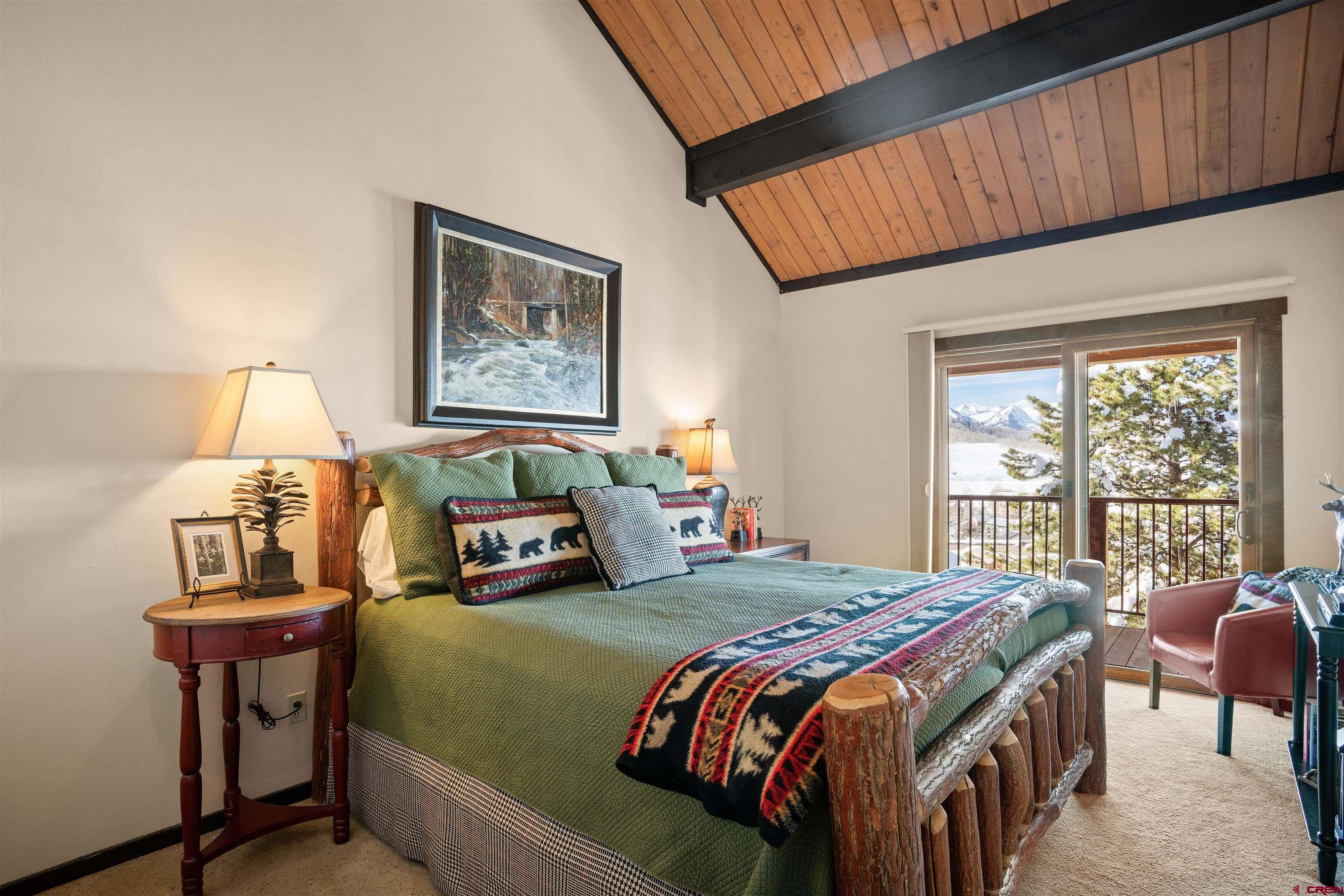 16 Hunter Hill Road, Unit K303 Crested Butte, CO 81225 - Photo 14 of 33 a bedroom with a bed and a table