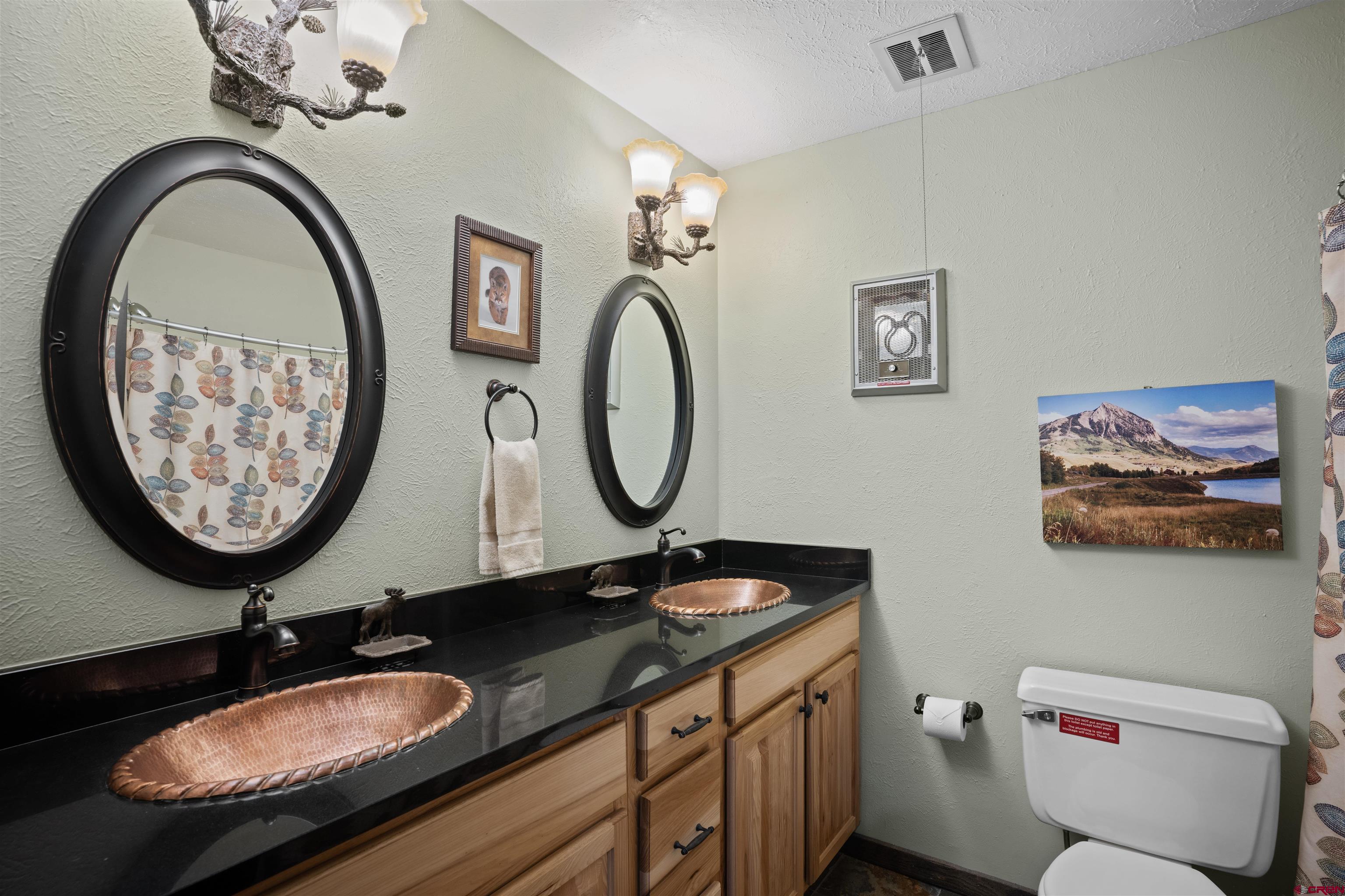16 Hunter Hill Road, Unit K303 Crested Butte, CO 81225 - Photo 15 of 33 a bathroom with a granite countertop toilet a sink and a mirror