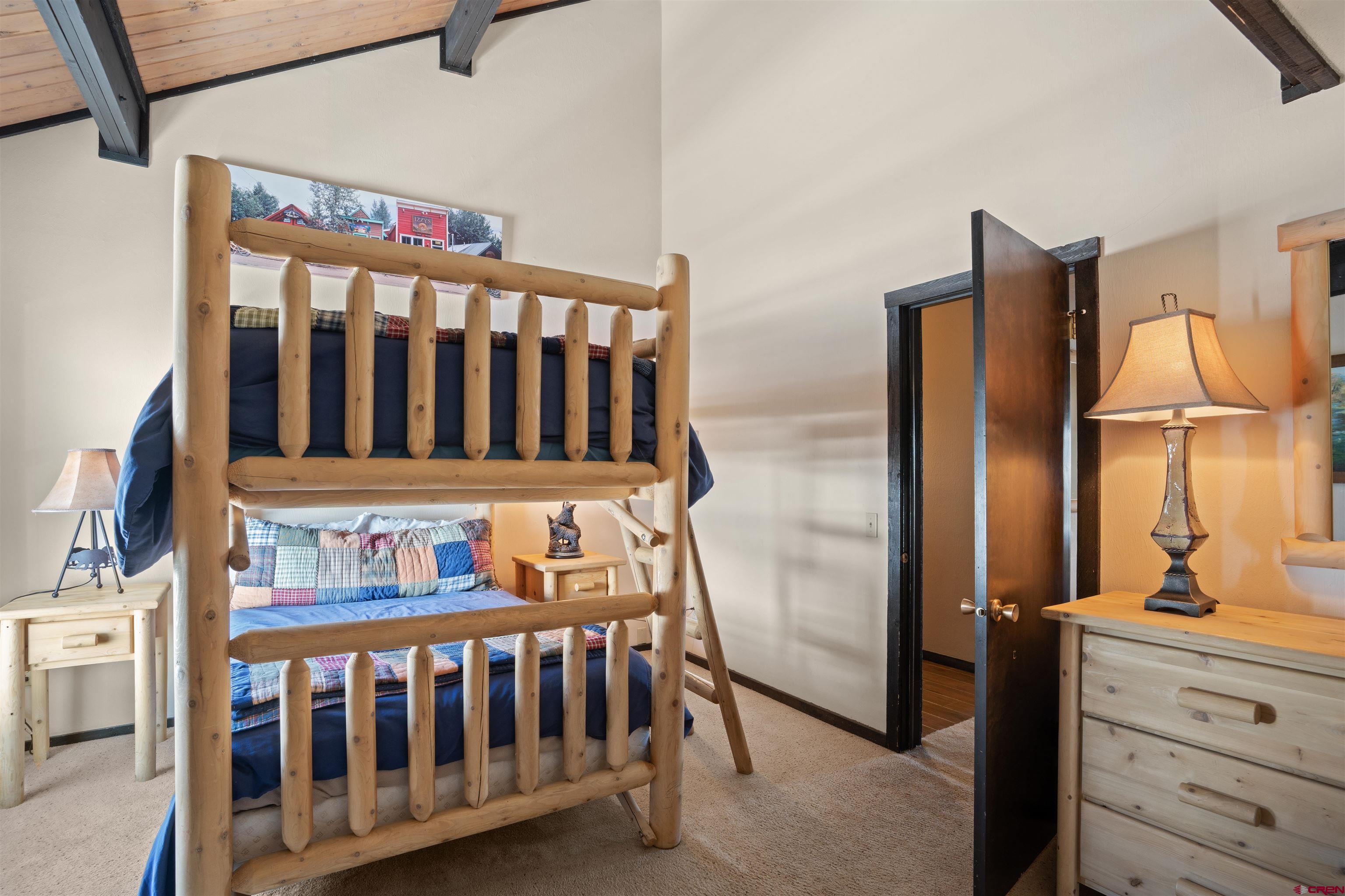 16 Hunter Hill Road, Unit K303 Crested Butte, CO 81225 - Photo 16 of 33 a bedroom with a bed and wooden floor