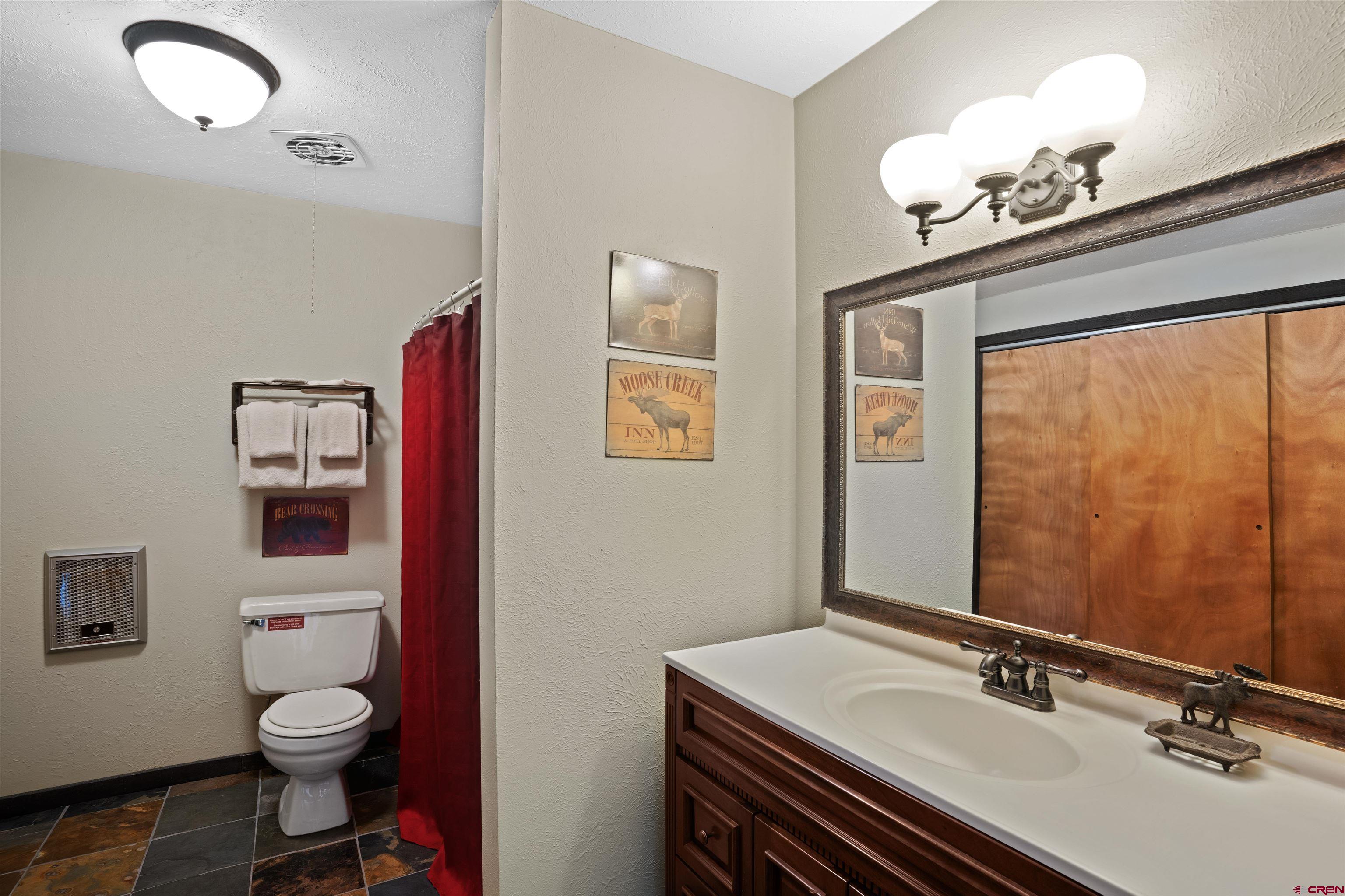 16 Hunter Hill Road, Unit K303 Crested Butte, CO 81225 - Photo 20 of 33 a bathroom with a sink a toilet and mirror