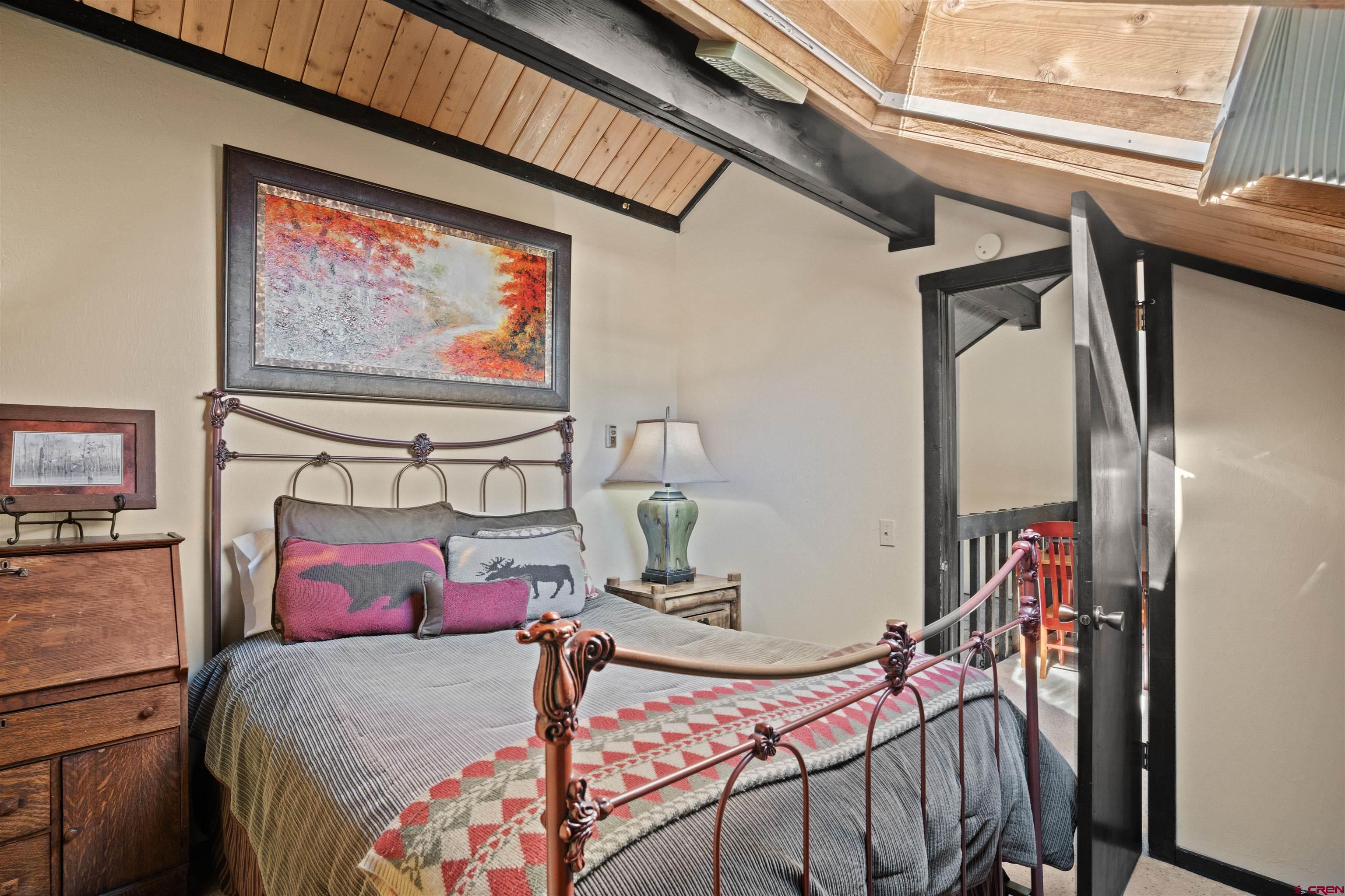 16 Hunter Hill Road, Unit K303 Crested Butte, CO 81225 - Photo 21 of 33 a bedroom with a bed and dresser