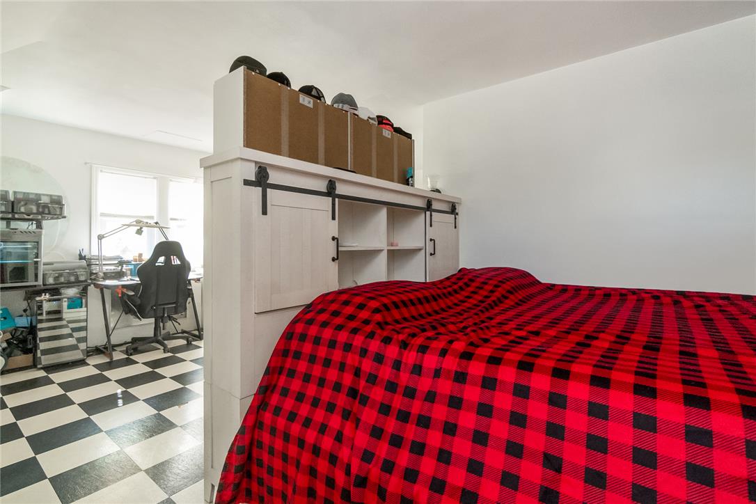 331 East Lizard Creek Road Lehighton, PA 18235 - Photo 36 of 37 A well-lit bedroom features distinct checkerboard flooring and a clever room divider with integrated storage.
