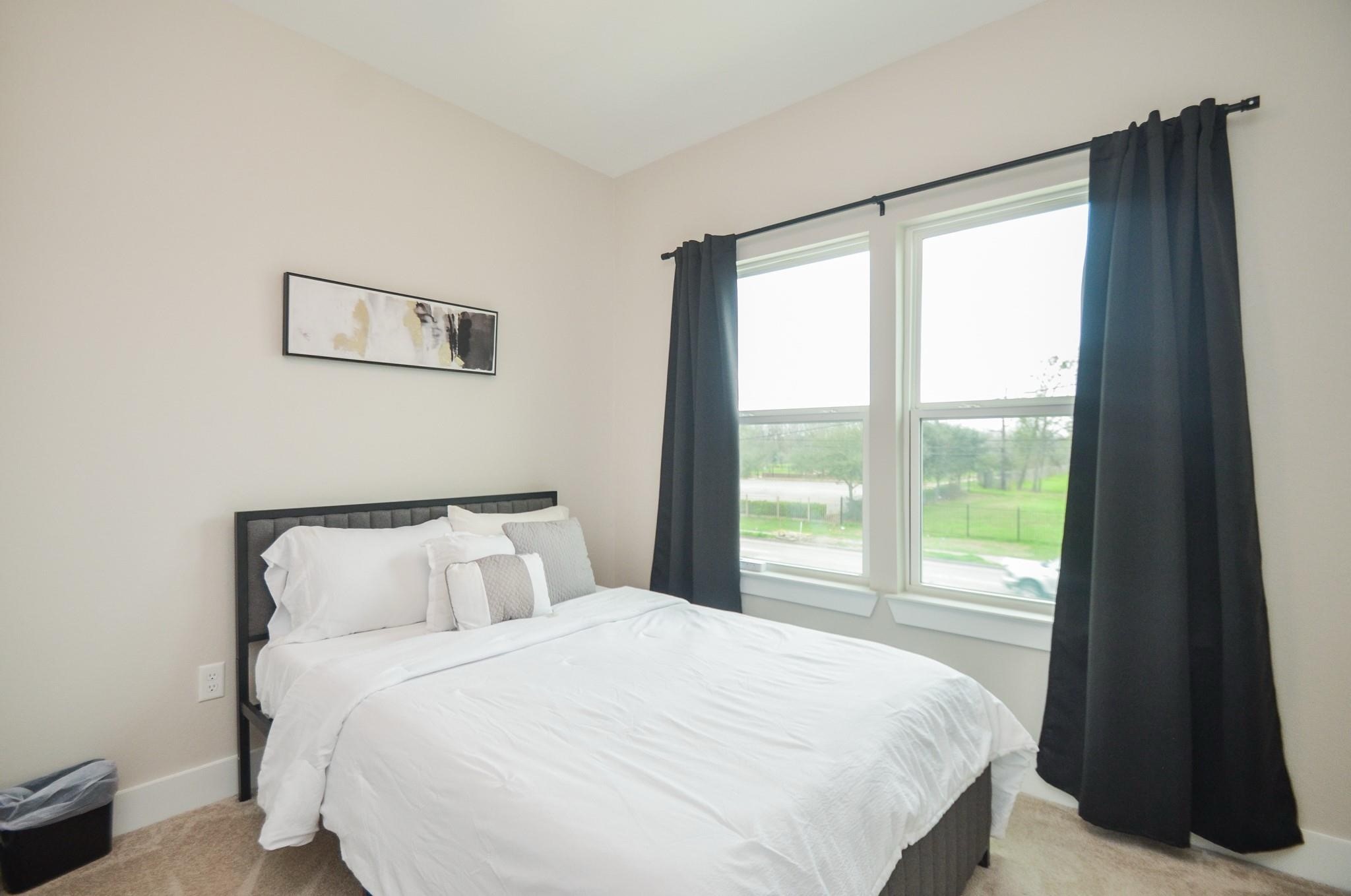 4511 Reed Road, Unit A Houston, TX 77051 - Photo 14 of 34 a bedroom with a bed and a large window