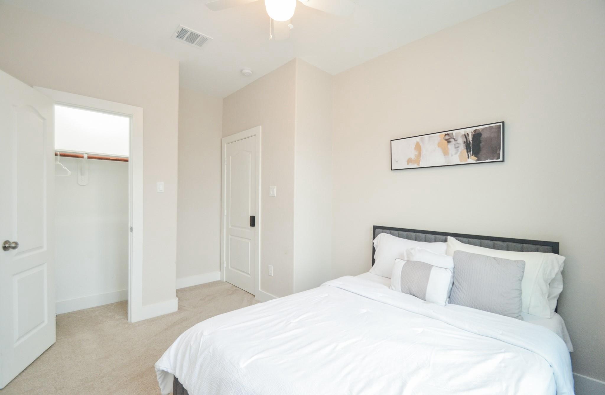 4511 Reed Road, Unit A Houston, TX 77051 - Photo 15 of 34 a bedroom with a bed and a night stand