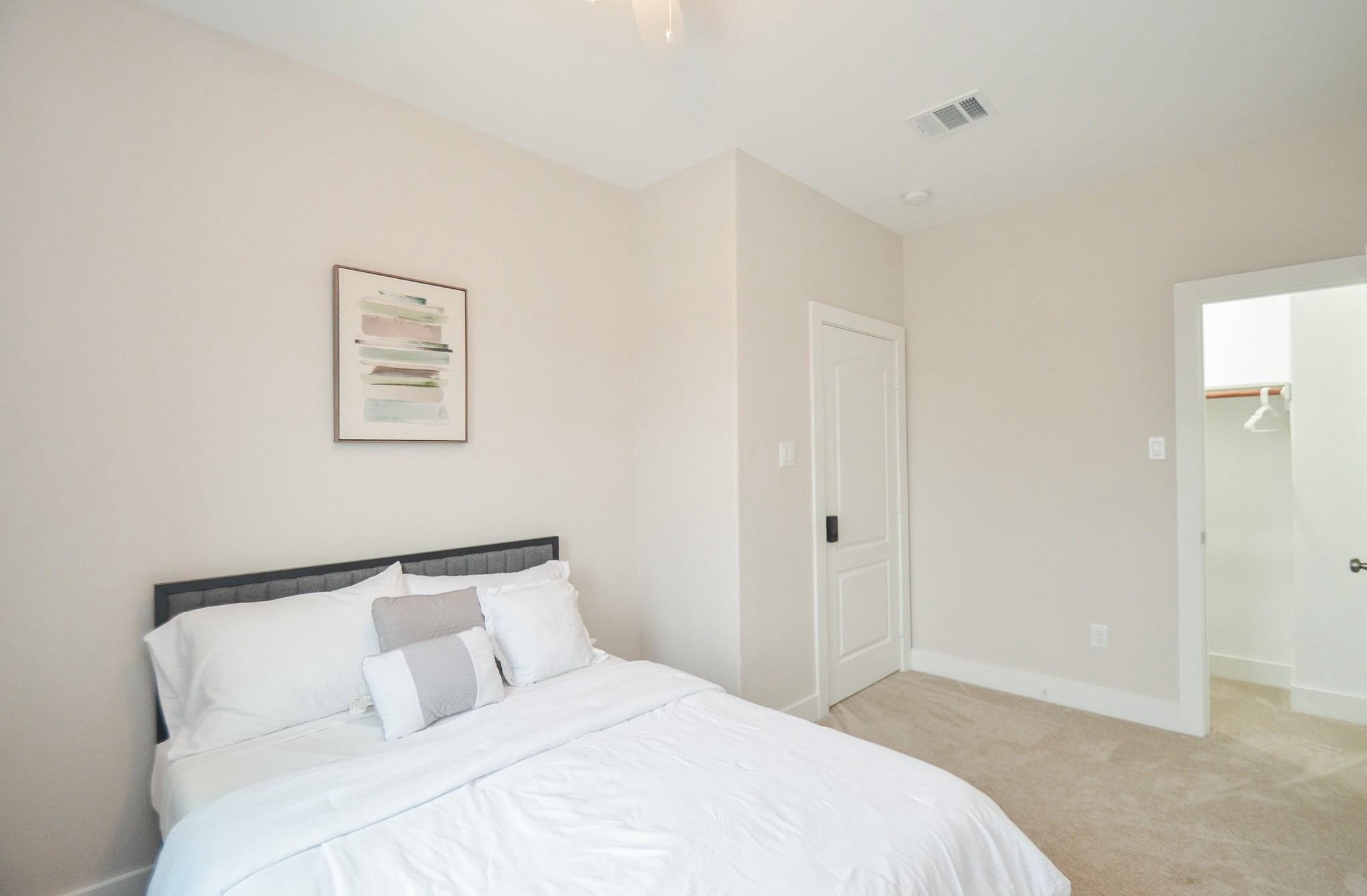 4511 Reed Road, Unit A Houston, TX 77051 - Photo 17 of 34 a bedroom with a bed and a painting on the wall