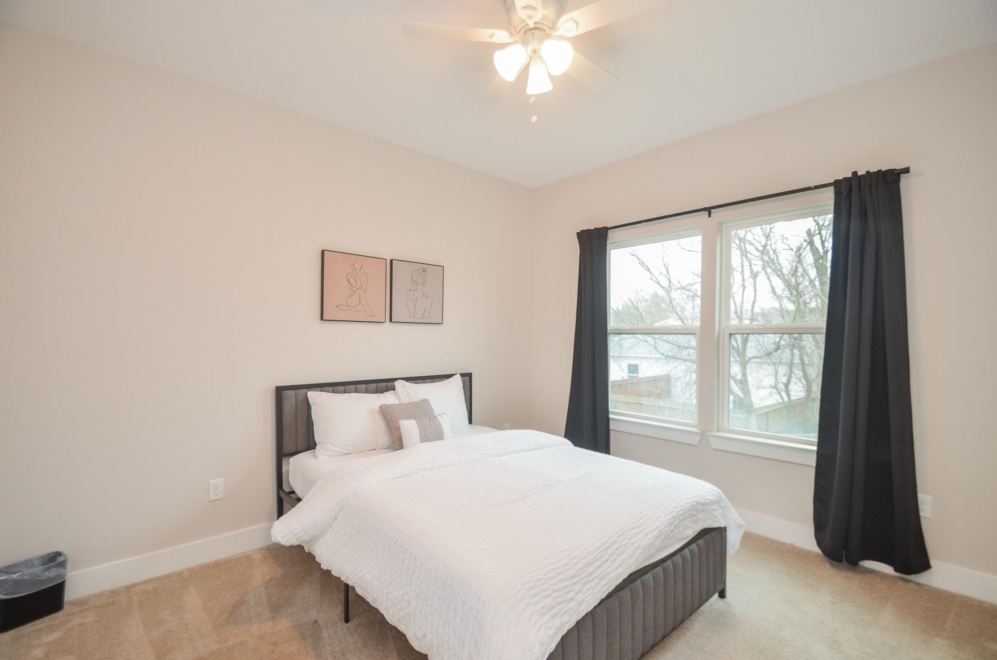 4511 Reed Road, Unit A Houston, TX 77051 - Photo 21 of 34 a bedroom with a large bed and a large window