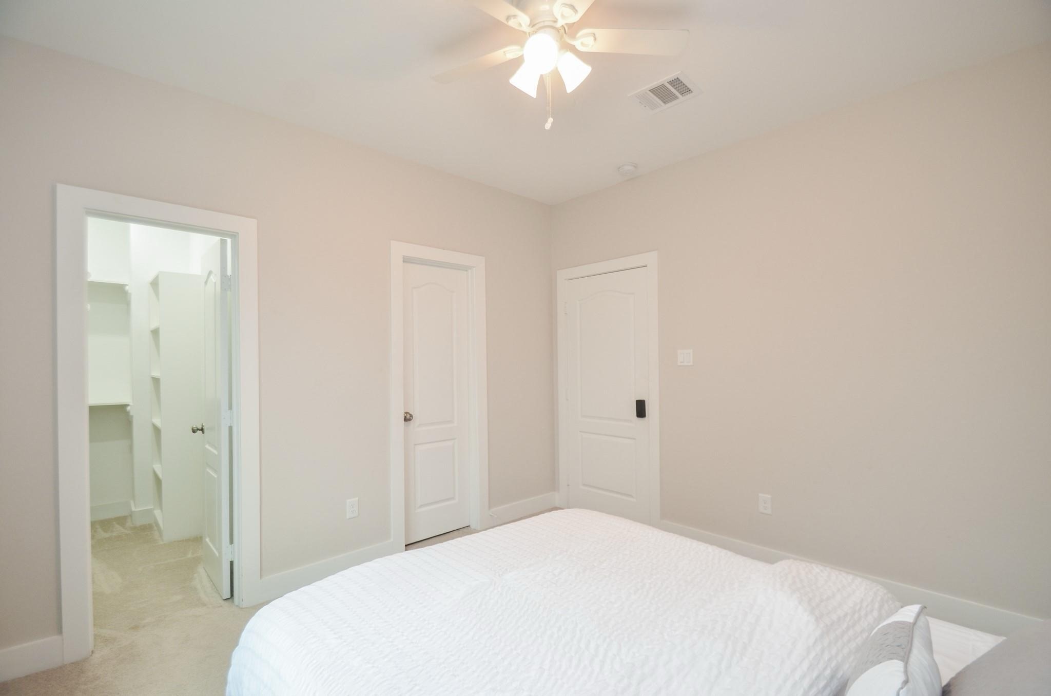 4511 Reed Road, Unit A Houston, TX 77051 - Photo 23 of 34 a bedroom with a bed and a chandelier